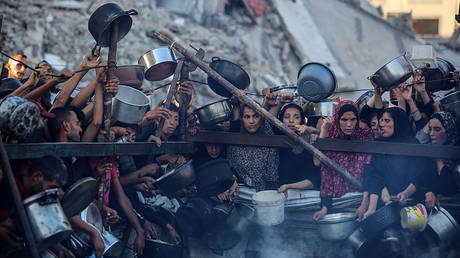 Palestinians gather at a food distribution point in Gaza City, on July 20, 2025.