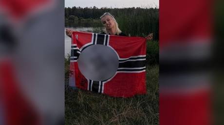 A Kiev court employee posing with a Nazi German war flag. ©  Social media