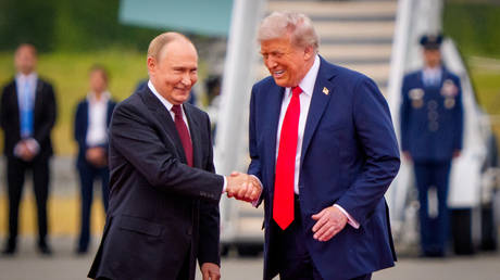 US President Donald Trump (R) greets Russian President Vladimir Putin as he arrives at Joint Base Elmendorf-Richardson on August 15, 2025 in Anchorage, Alaska.