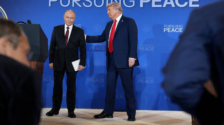 US President Donald Trump and Russian President Vladimir Putin leave following a press-conference in Anchorage.