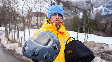 Vladislav Geraskevich displays the helmet that got him disqualified from the Milano Cortina Winter Olympics in Italy, February 12, 2026 © Getty Images / Andrew Milligan
