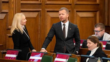 FILE PHOTO: For Stability! party MP Aleksey Roslikov (C) in the Latvian parliament.