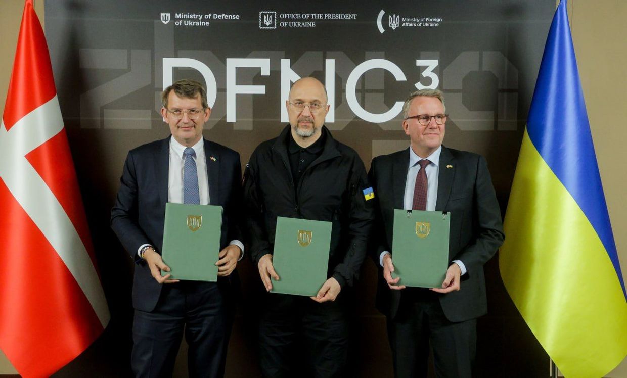 Danish Defense Minister Troels Lund Poulsen (L) signs a defense deal with then-Ukrainian Defense Minister Denis Shmigal and Danish Business Minister Morten Bodskov in Kiev, Ukraine, October 6, 2025