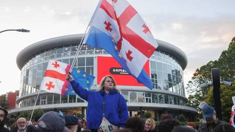 Anti-government protesters wave Georgian and EU flags during a demonstration in Tbilisi, Georgia, on May 30, 2026.